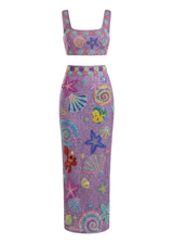 Purple dress with colorful sea-themed patterns on a white background