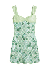 Green mermaid scale patterned dress on a white background