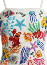 Colorful beaded design of sea creatures on a white background