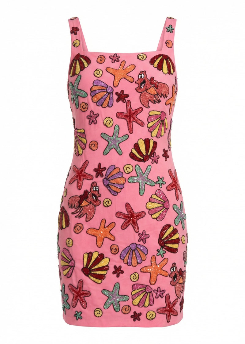 Pink dress with colorful sea-themed pattern on a white background