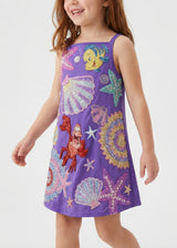 Child wearing a purple dress with colorful sea-themed embellishments on a white background