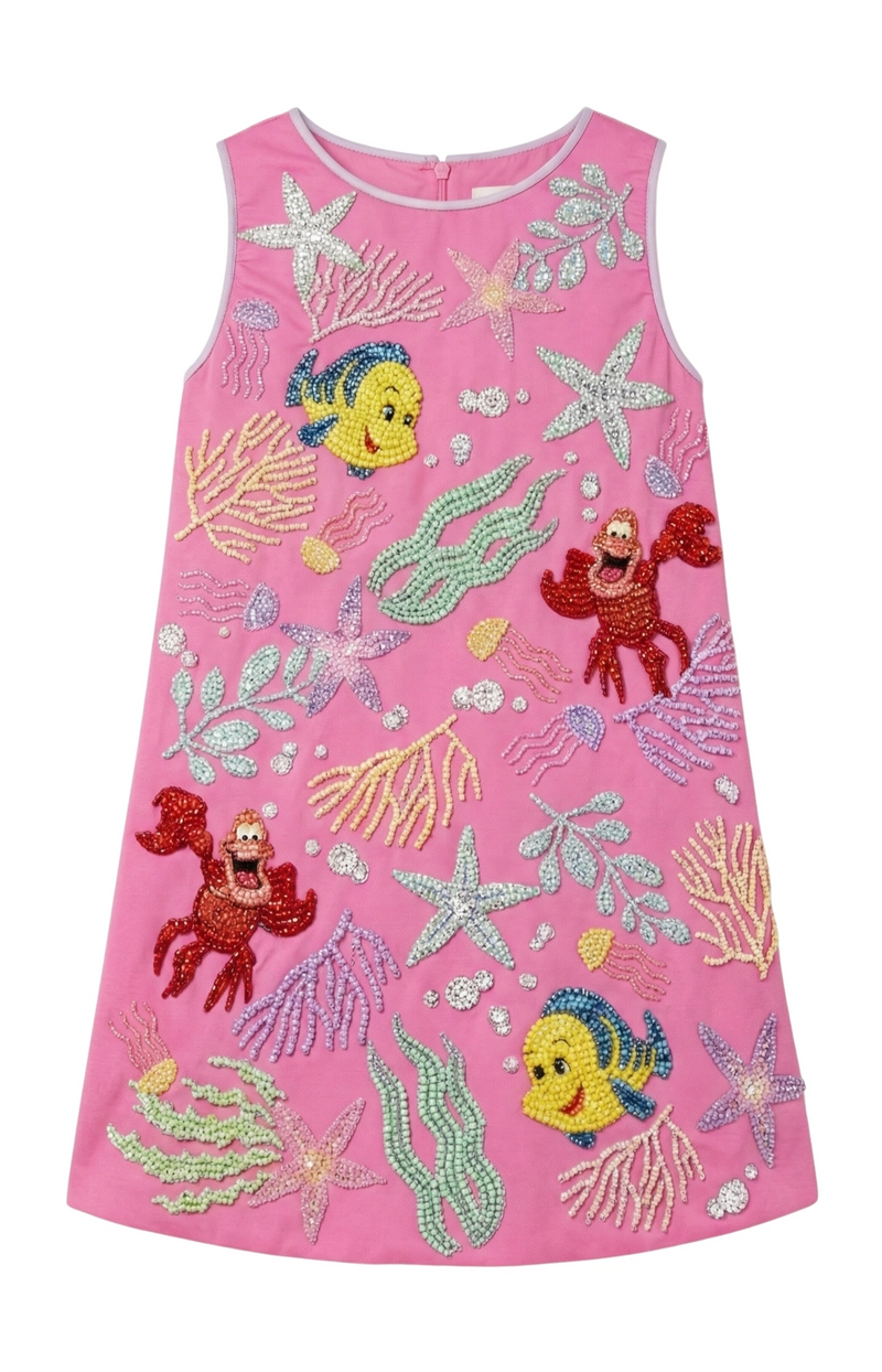 Pink dress with animated character designs on a white background