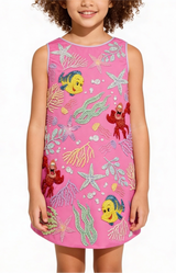 Child wearing a pink dress with undersea-themed sequin designs on a white background