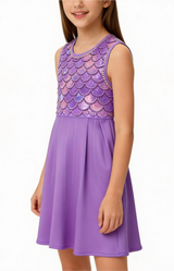 Young girl wearing a purple dress with fish-scale pattern on a white background