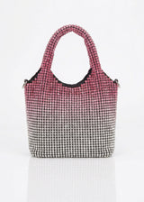 Handbag with pink top section and black and white patterned bottom section on a white background