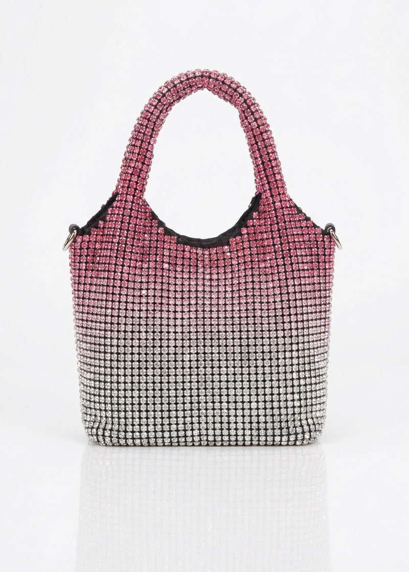 Handbag with pink top section and black and white patterned bottom section on a white background