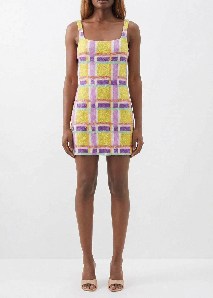 Person wearing a colorful plaid dress on a white background