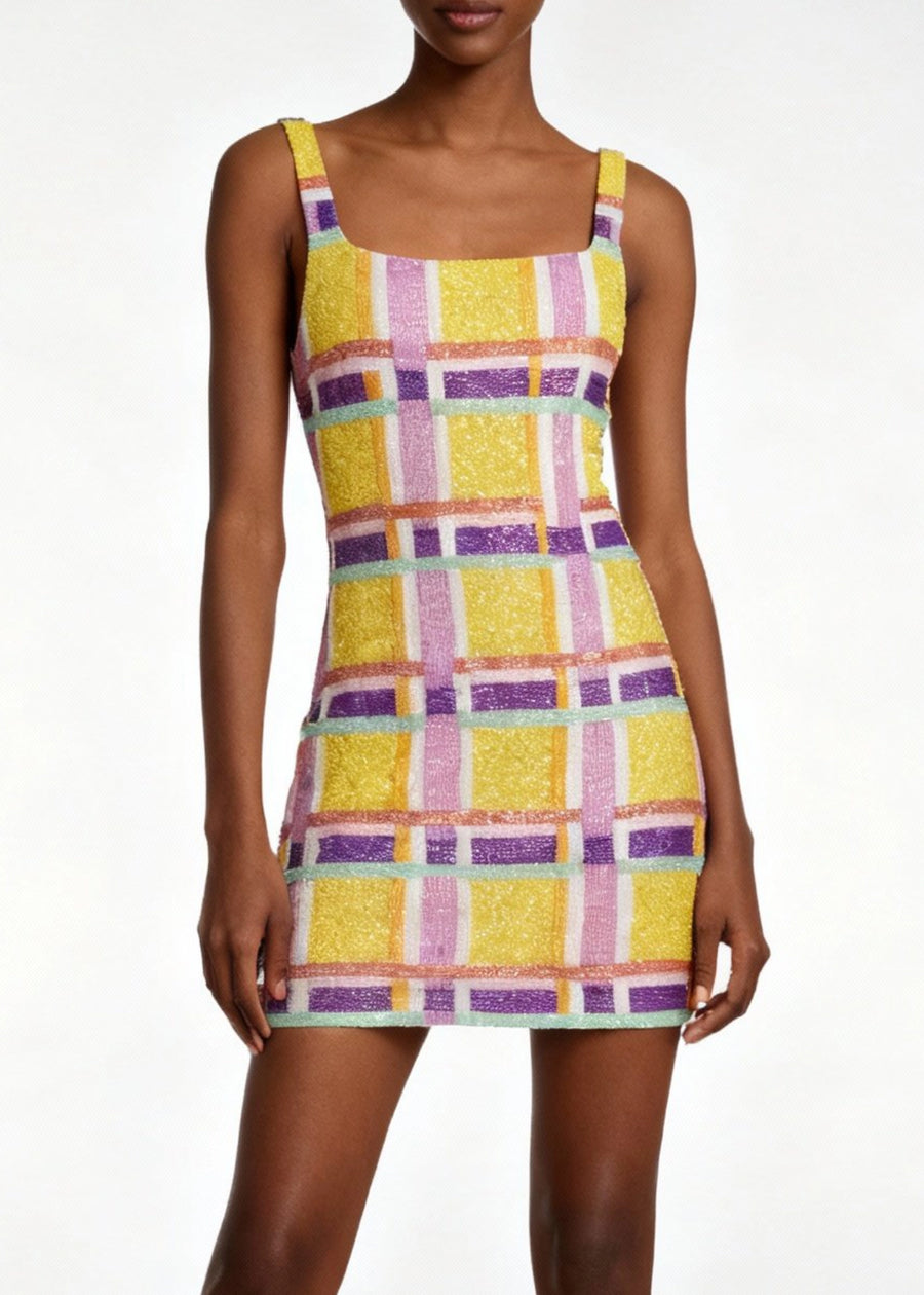 Woman wearing a colorful checkered dress on a white background