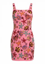 Pink dress with colorful sea-themed pattern on a white background
