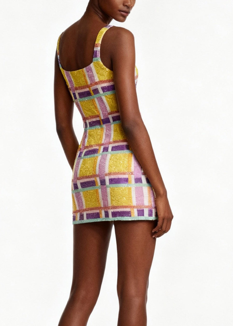 Woman wearing a colorful checkered dress on a white background