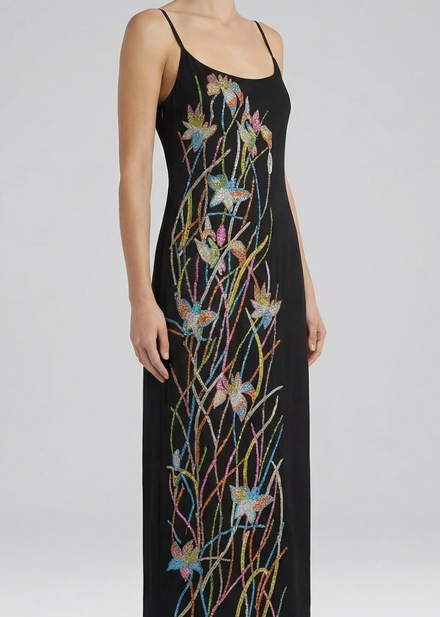 Black dress with colorful floral and branch embroidery on a white background