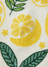 Close-up of a beaded fabric with lemon and leaf patterns